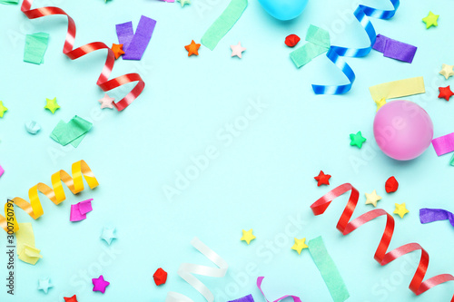 Colorful ribbons with rubber balloons and paper stars on blue background