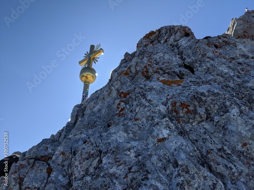 Mountaintop with golden cross standing on it