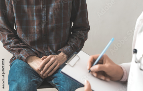 Male patient sits at the doctor's consultation. The problem of the prostate cancer. Std 