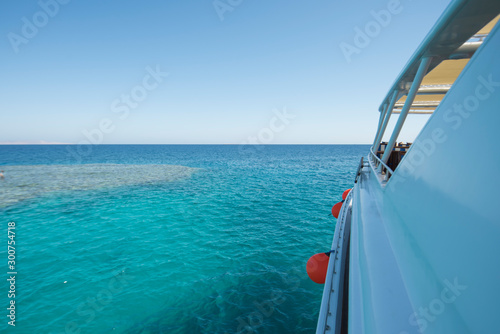 View down side of luxury yacht on tropical sea