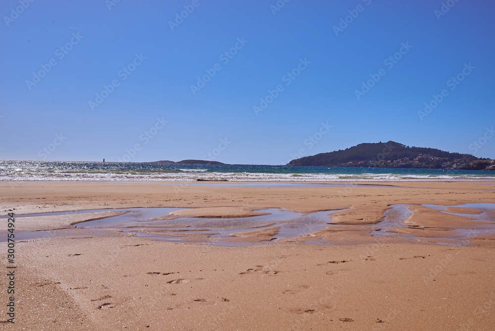 Empty beach with low tide in Playa America near Vigo, Galicia