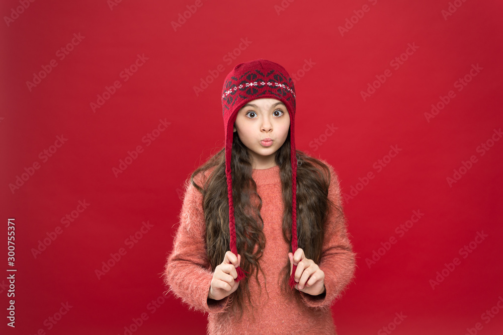 Its cold outside. Winter outfit. Little kid wear knitted hat. Stay warm. Little girl winter fashion accessory. Small child long hair wear hat burgundy background. Cute model enjoy winter style Its cold outside. Winter outfit. Little kid wear knitted hat. Stay warm. Little girl winter fashion accessory. Small child long hair wear hat burgundy background. Cute model enjoy winter style