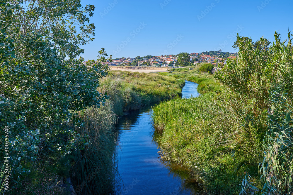 Fototapeta premium End of a river at Playa America beach in Vigo
