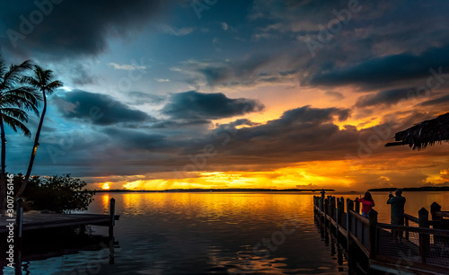 Spectacular sunset at Islamorada in the Florida Keys. The sun comes out just after a storm and lights up the sky with beautiful colors photo