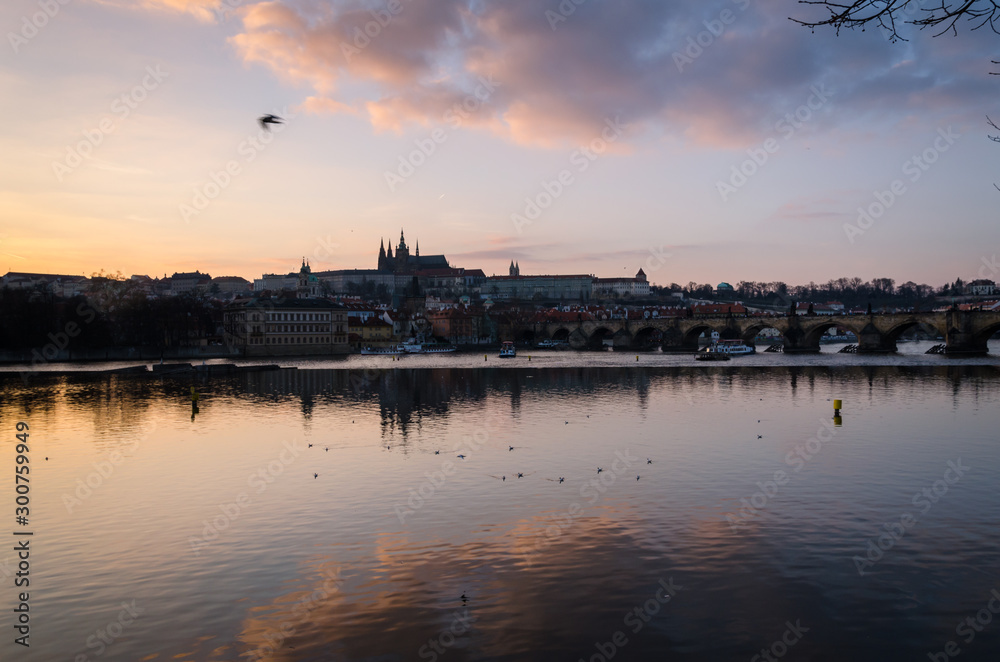 Reflections of the city on the Moldava river at sunset, Prague, Czech Republic