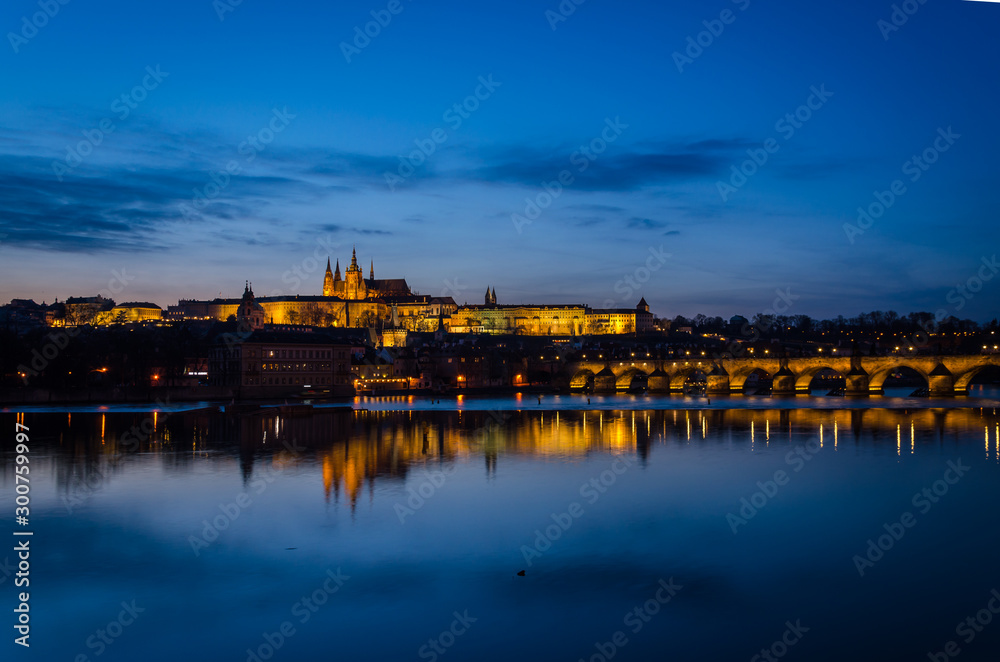 Night view of Prague at blue hour with the lights reflected on the Moldava river, Prague, Czech Republic