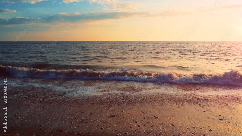 Amazing sunset with endless horizon and foamy sea waves in sand Ostia beach near Rome, Italy Amazing sunset with endless horizon and foamy sea waves in sand Ostia beach near Rome, Italy