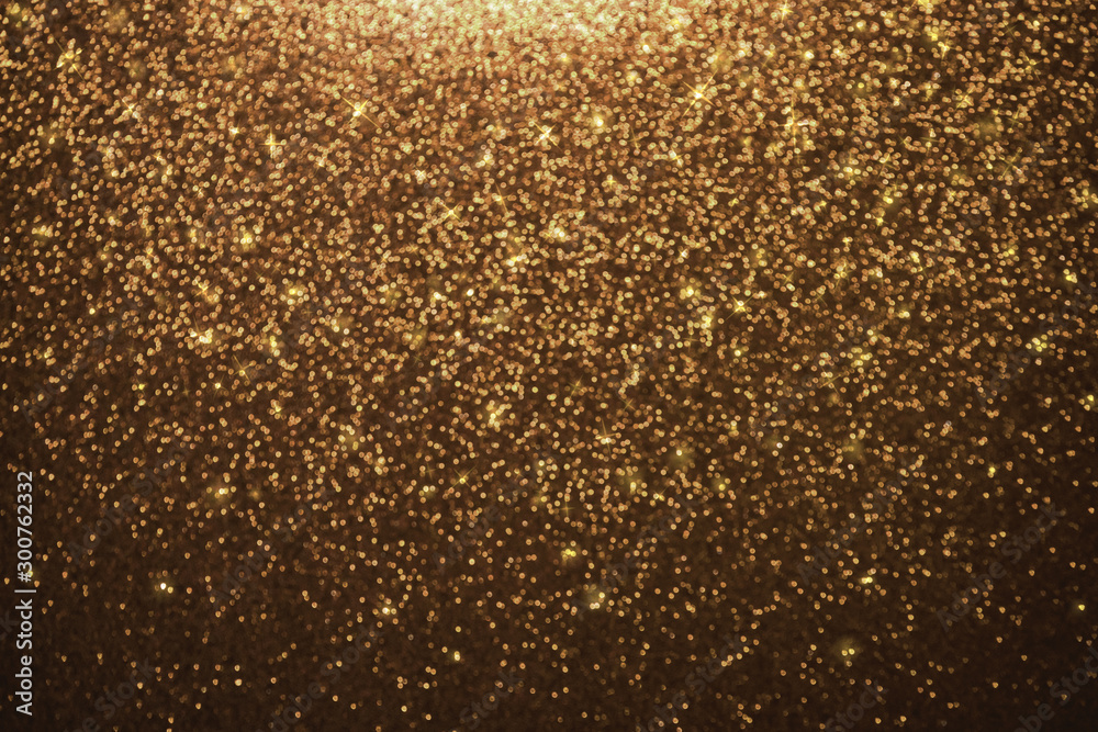 Abstract gold glitter lights background. defocused