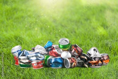 Crumpled tin cans on the green grass