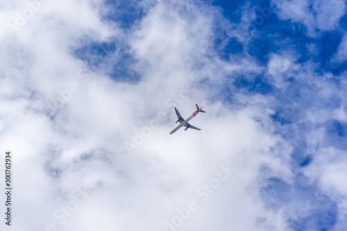 Airplane in the sky. Commercial airplane jetliner, travel and business concept.
