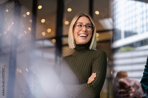 Portrait of happy young woman in the city photo