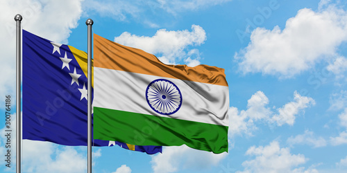 Bosnia Herzegovina and India flag waving in the wind against white cloudy blue sky together. Diplomacy concept, international relations.
