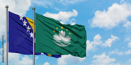 Bosnia Herzegovina and Macao flag waving in the wind against white cloudy blue sky together. Diplomacy concept, international relations.