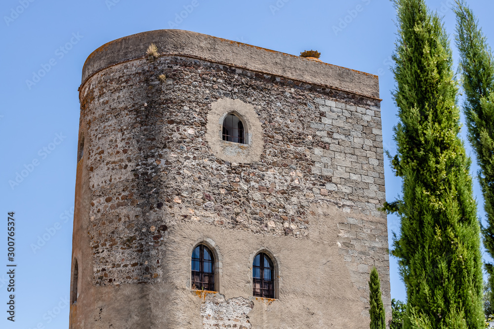Stone thick tower in a sunny day  in Redondo, Alentejo. Historic castle in Portugal.