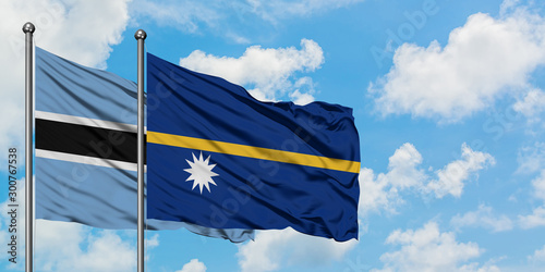 Botswana and Nauru flag waving in the wind against white cloudy blue sky together. Diplomacy concept, international relations.