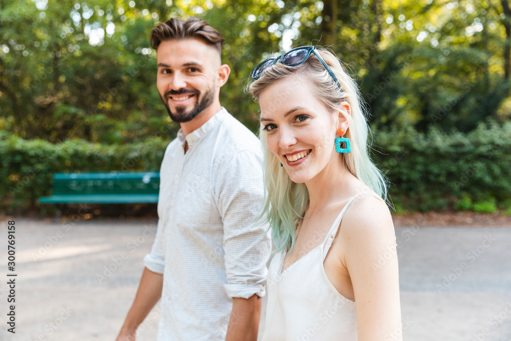 Portrait of happy young couple walking in a park Portrait of happy young couple walking in a park