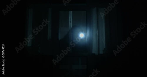 Thief is Looking inside the House Through the Windows with Flashlight Opening the Back Door and Entering the Property at Night Shot on Red Epic
