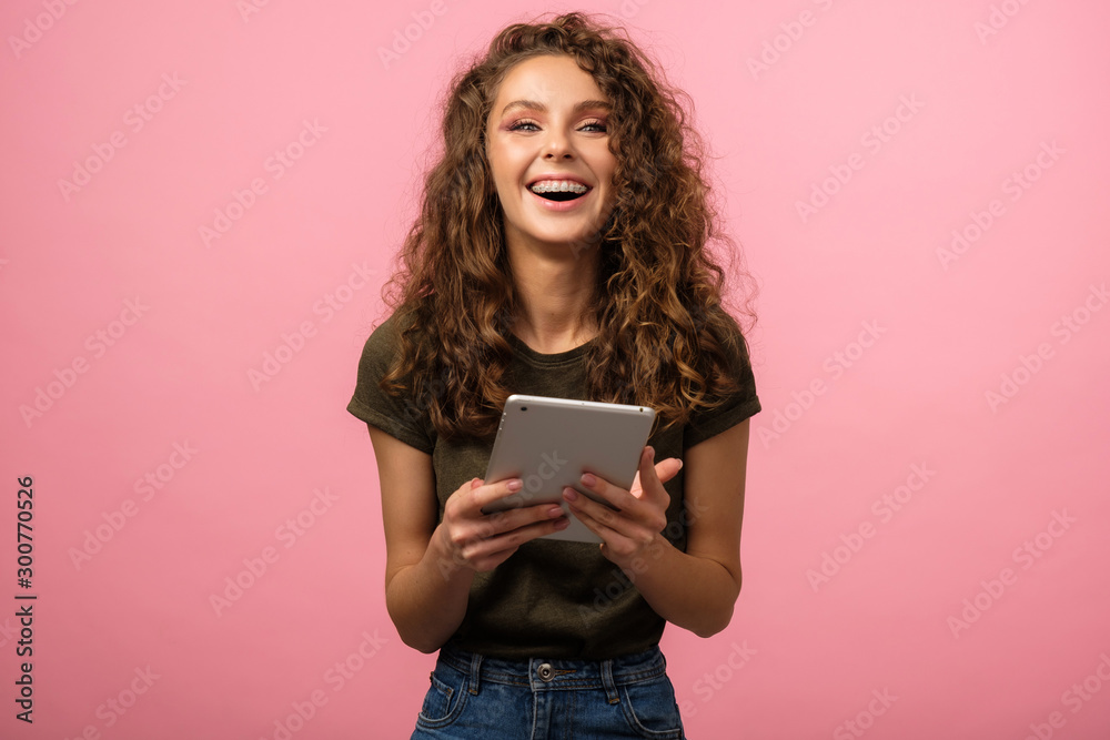 Pretty teen with tablet on pink Pretty teen with tablet on pink