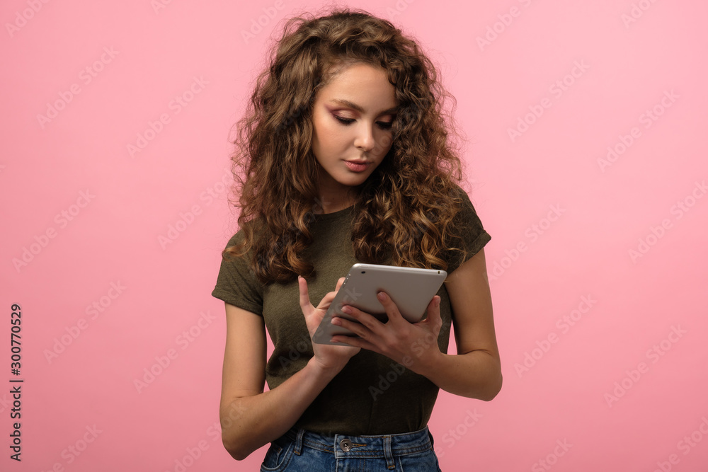 Pretty teen with tablet on pink Pretty teen with tablet on pink