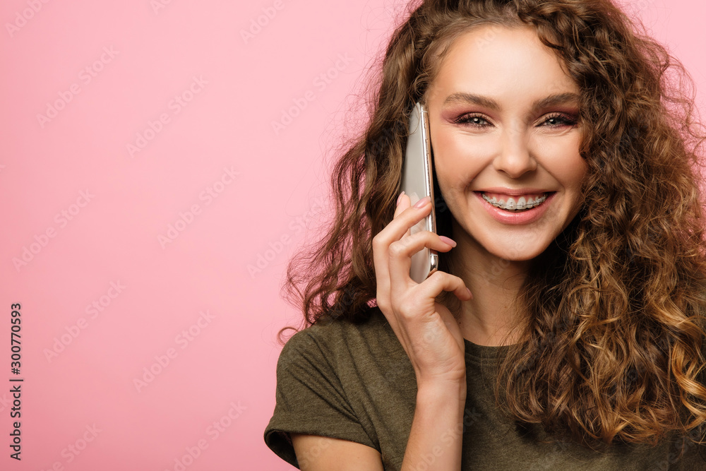 Pretty girl with cellphone on pink background Pretty girl with cellphone on pink background