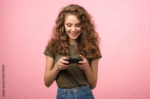 Pretty gamer girl isolated on pink background