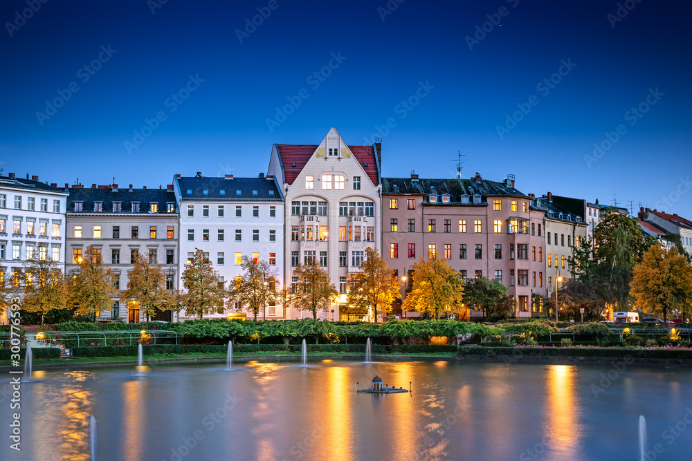 Illuminated cozy Engelbecken embankment in the evening in Berlin, Germany