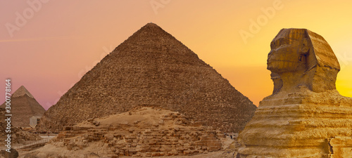 Sphinx against the backdrop of the great Egyptian pyramids. Africa  Giza Plateau. 