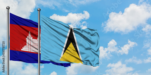 Cambodia and Saint Lucia flag waving in the wind against white cloudy blue sky together. Diplomacy concept, international relations.