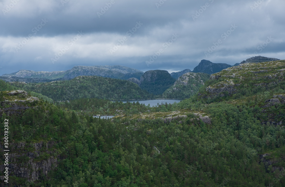 Mountains on the way to the Preachers Pulpit Rock in fjord Lysefjord - Norway - nature and travel background. Lake Tjodnane, july 2019 Mountains on the way to the Preachers Pulpit Rock in fjord Lysefjord - Norway - nature and travel background. Lake Tjodnane, july 2019