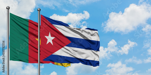 Cameroon and Cuba flag waving in the wind against white cloudy blue sky together. Diplomacy concept, international relations.