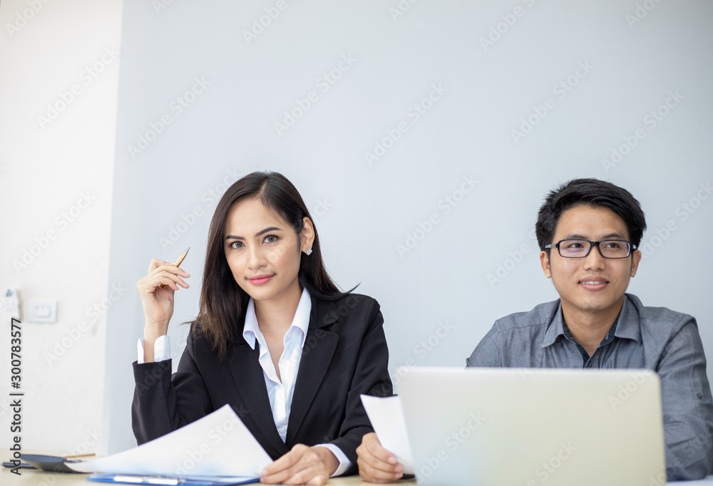 Asian businessmen and group using notebook for business partners discussing documents and ideas at meeting and business women smiling happy for working
