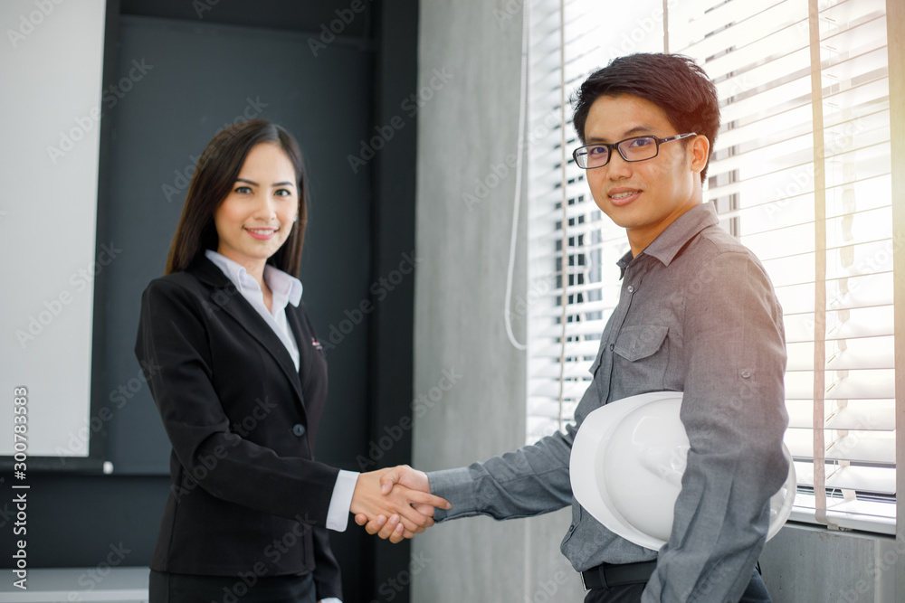 Asian Business people shaking hands and smiling their agreement to sign contract and finishing up a meeting Asian Business people shaking hands and smiling their agreement to sign contract and finishing up a meeting