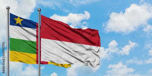Central African Republic and Indonesia flag waving in the wind against white cloudy blue sky together. Diplomacy concept, international relations.