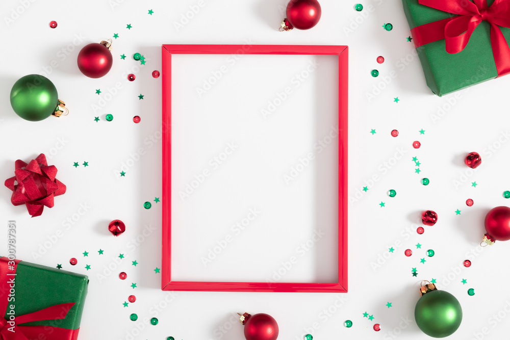 Christmas modern composition. Red photo frame, Xmas decorations on white background. Christmas, New Year, winter concept. Flat lay, top view, copy space - obrazy, fototapety, plakaty 