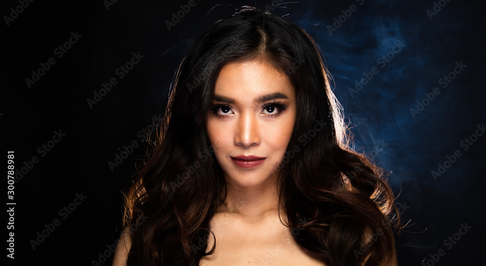 Sensual Look of Fashion Model High Make Up curl style hair Red Lips, Woman wear Fur and look at camera in beauty shot, studio lighting dark fog smoke background backlit light Sensual Look of Fashion Model High Make Up curl style hair Red Lips, Woman wear Fur and look at camera in beauty shot, studio lighting dark fog smoke background backlit light
