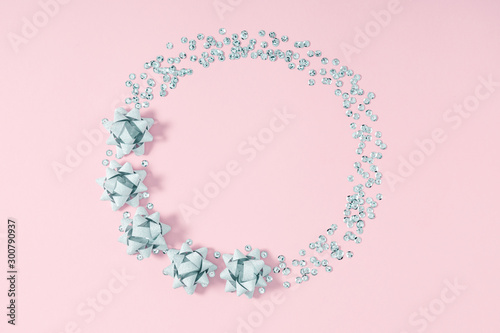 Christmas  holiday composition. Wreath made of pastel blue decorations on pink background. Christmas, New Year, winter concept. Flat lay, top view, copy space © prime1001