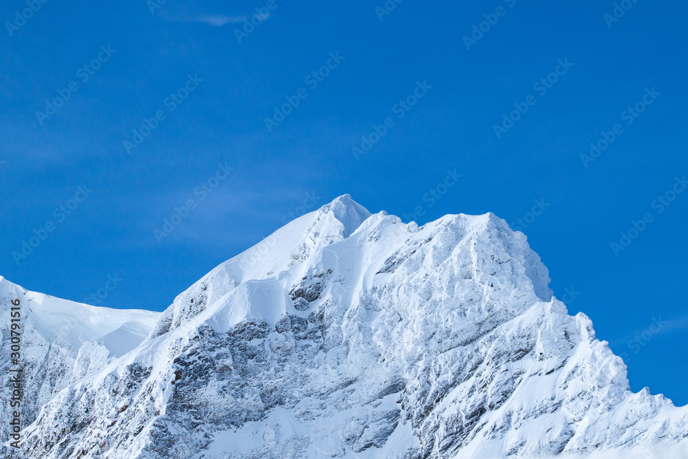 Wonderful Winter Landscape. Splendid Alpine scenery: Snowy Mountains at Grindelwald, Switzerland. Snow-covered mountains. Winter travel concept.