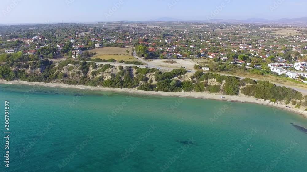 Aerial view of beautiful turquoise blue sea and the coast with road and houses Aerial view of beautiful turquoise blue sea and the coast with road and houses
