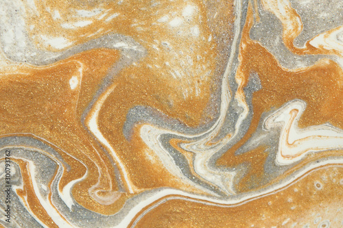 Metallic gold and silver provide texture to this curvaceous abstract background. photo