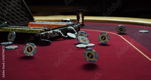 Poker table with poker chips in suitcase and falling on the table in casino. Poker chips for gambling card game.