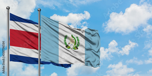 Costa Rica and Guatemala flag waving in the wind against white cloudy blue sky together. Diplomacy concept, international relations.