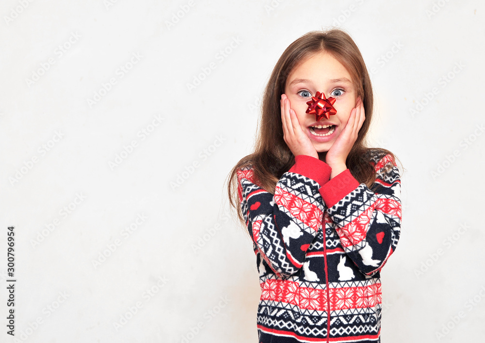 Cute little girl in pajama with a bow on her nose posing on light background. - obrazy, fototapety, plakaty 