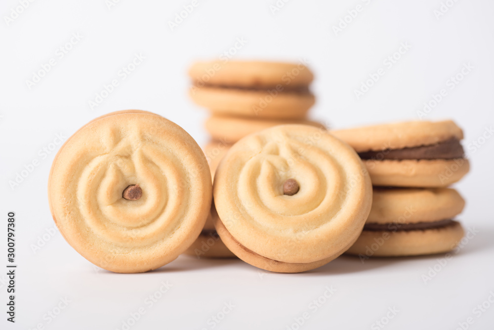 Cookies stuffed with coffee cream stacked on a white background. Cookies stuffed with coffee cream stacked on a white background.