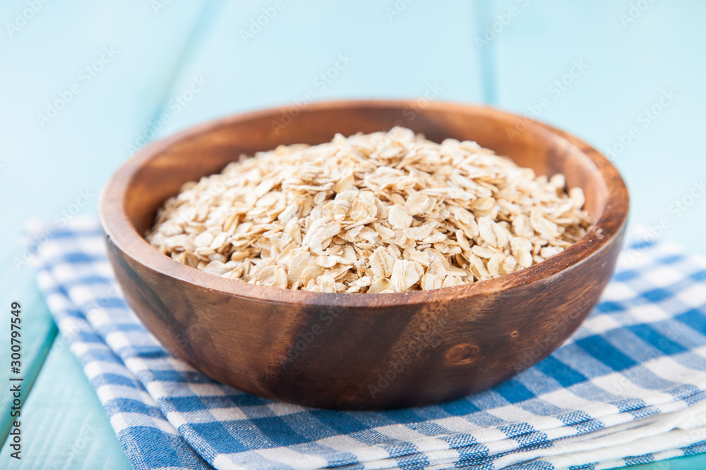 Oat flakes in a bowl on a table, selective focus, copy space Oat flakes in a bowl on a table, selective focus, copy space