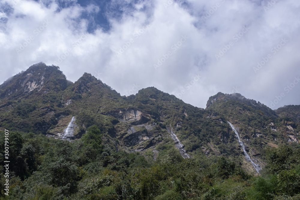 Fototapeta premium view of mountains and three waterfalls