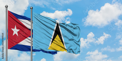 Cuba and Saint Lucia flag waving in the wind against white cloudy blue sky together. Diplomacy concept, international relations.