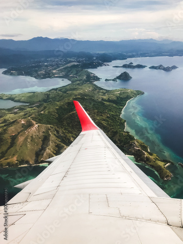 Tropical island coastline view from the plane. Travel and vacations concept. Flores, Labuan Bajo. Indonesia photo
