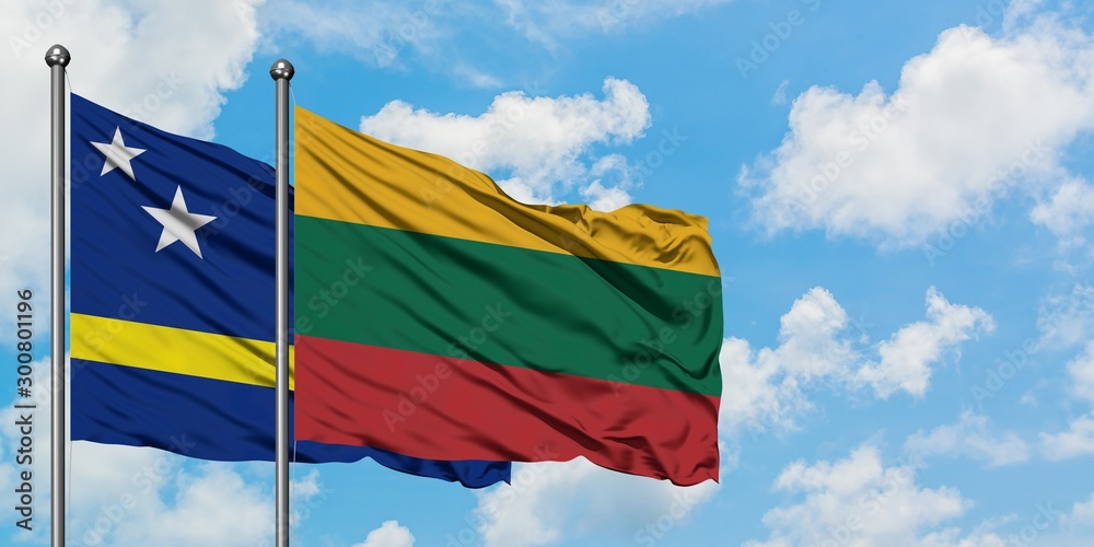 Curacao and Lithuania flag waving in the wind against white cloudy blue sky together. Diplomacy concept, international relations. Curacao and Lithuania flag waving in the wind against white cloudy blue sky together. Diplomacy concept, international relations.