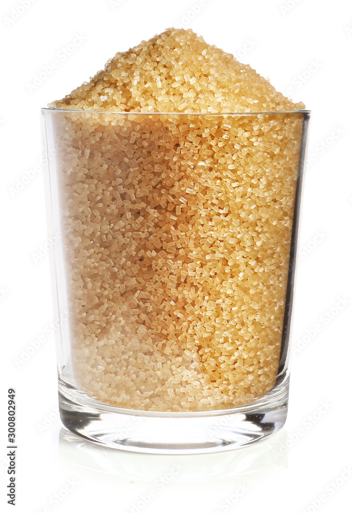Glass of brown sugar on white background Glass of brown sugar on white background