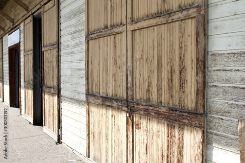 Rustic vintage building on a railroad train loading dock with large old wooden doors